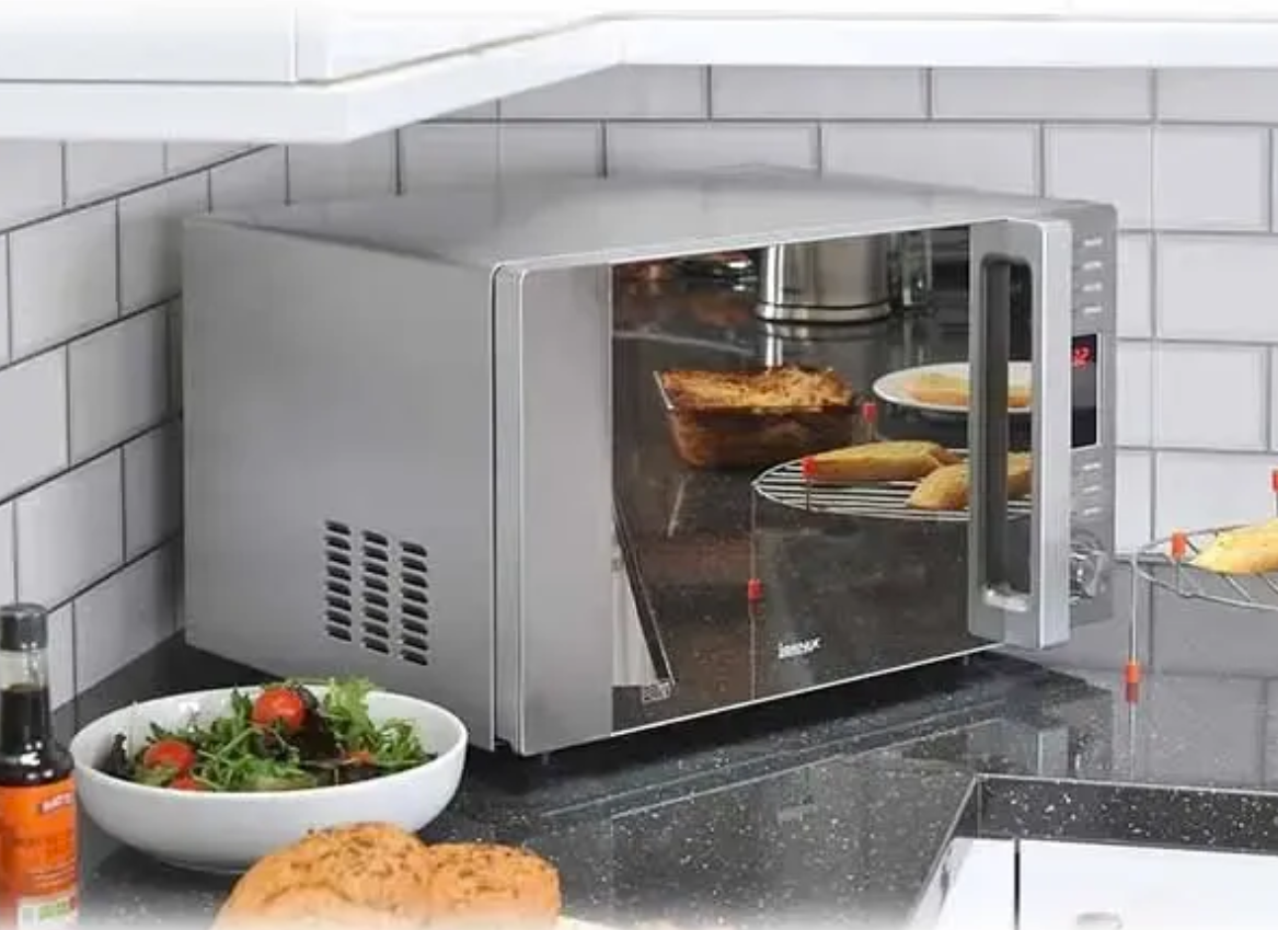 Microwave on kitchen worktop.